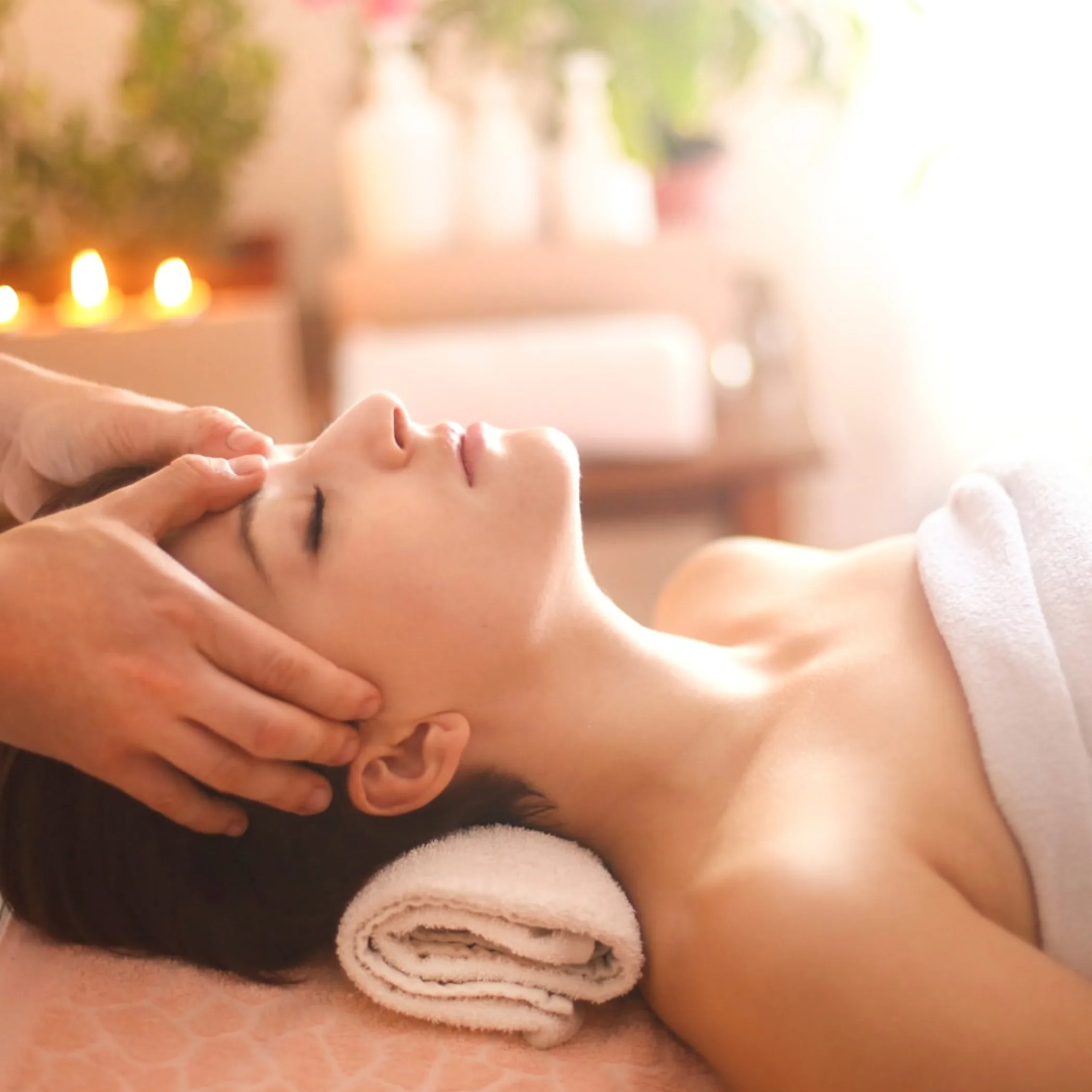 woman applying moisturizer to face